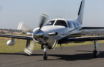 Photo of a small piston-engine plane on a runway